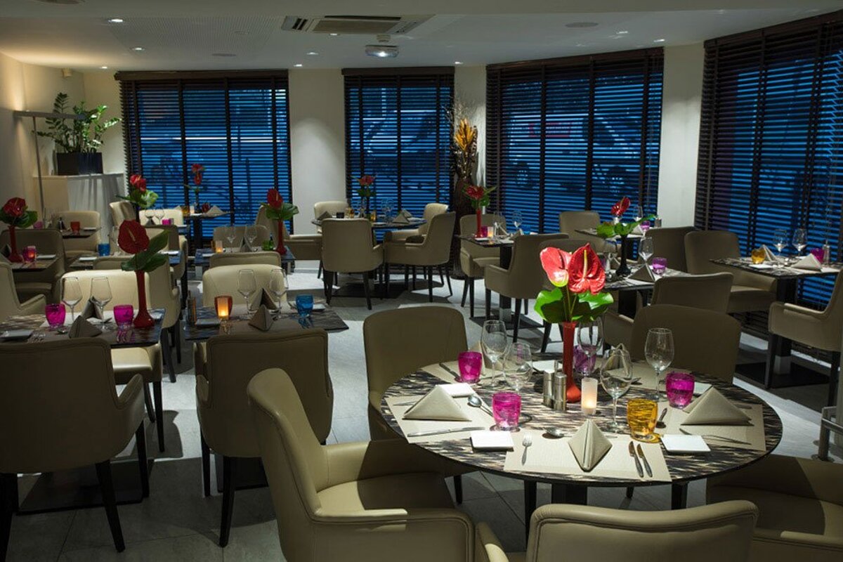 A restaurant with a lot of tables and chairs