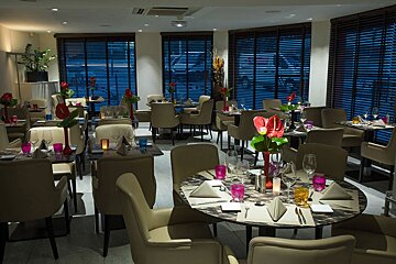 A restaurant with a lot of tables and chairs