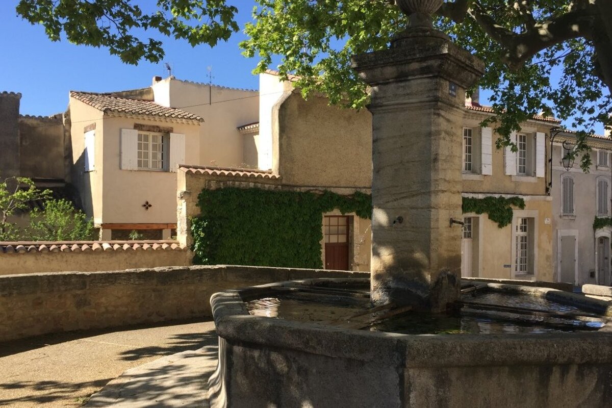 a fountain in a village in provence