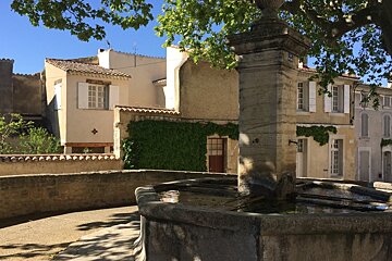 a fountain in a village in provence