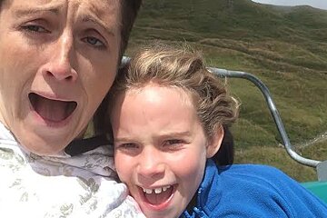 two people screaming on a chair lift