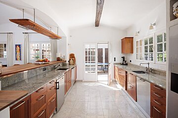 A kitchen with wooden cabinets and granite counter tops