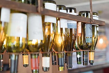A bottle of riesling wine hangs from a shelf