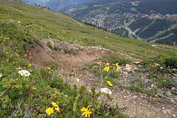 a berm on a down hill mountain bike track in meribel