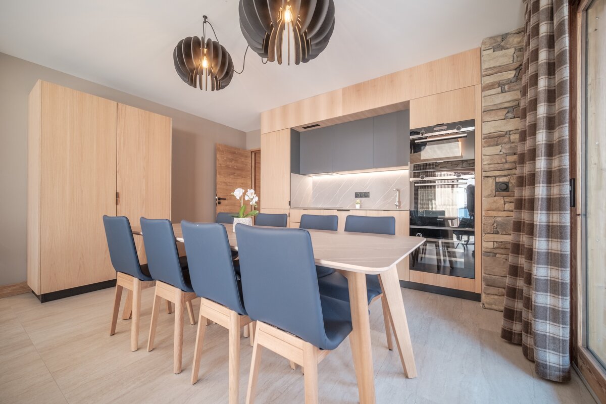 A kitchen with a table and chairs in it