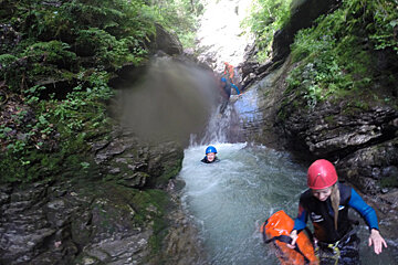 three people canyoning in a river near Morzine