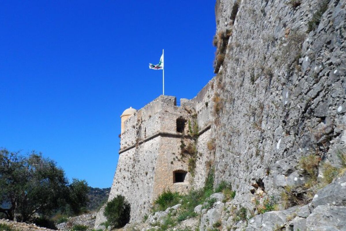 thick stone walls at a fort and a flag flying on top
