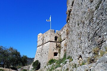 thick stone walls at a fort and a flag flying on top
