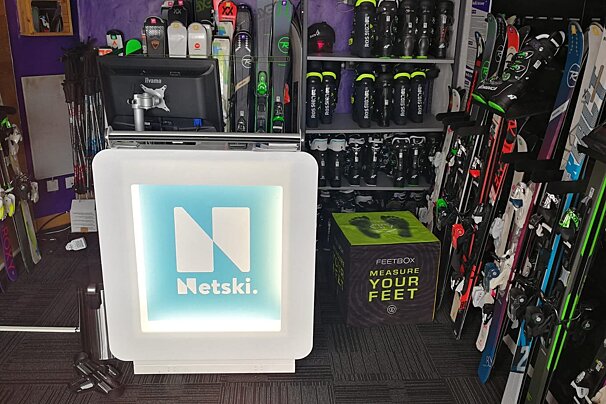 A store with skis and a box that says feetbox measure your feet