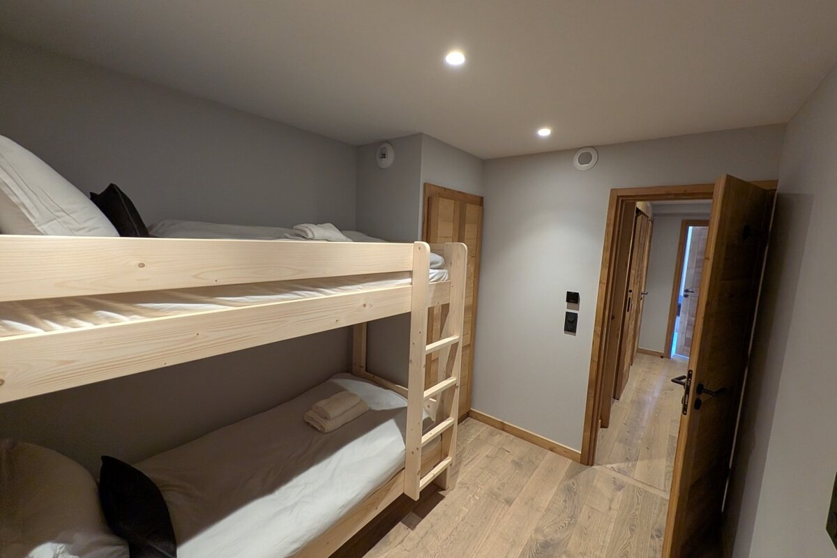 A bedroom with bunk beds and a door