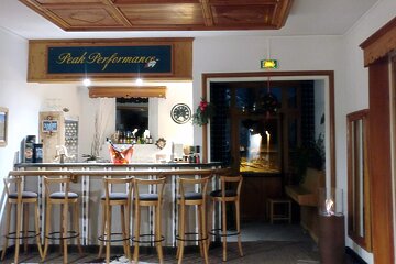 A bar with a sign above it that says peak performance