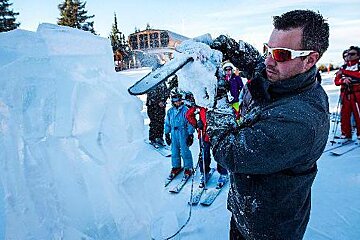 a man with a chainsaw ice sculpting