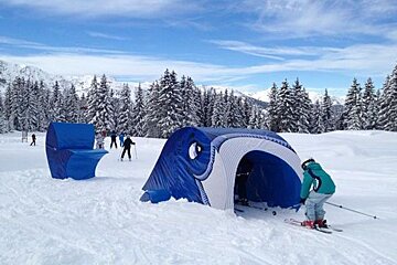 skiers going through tunnels