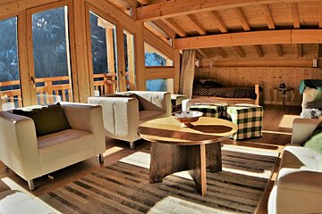 A living room filled with furniture and a table with a bowl on it
