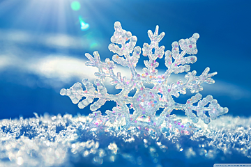 A snowflake with a blue sky in the background