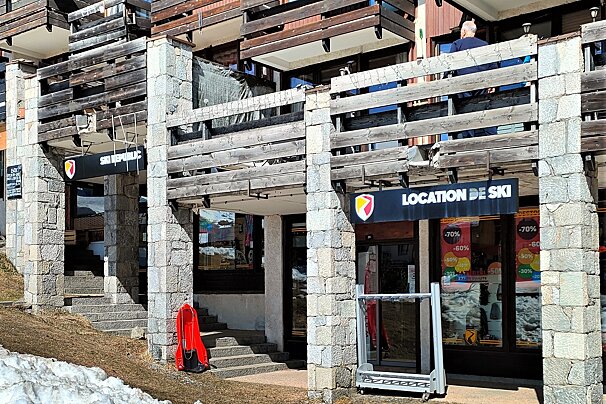 A stone and wood building in a ski resort features 