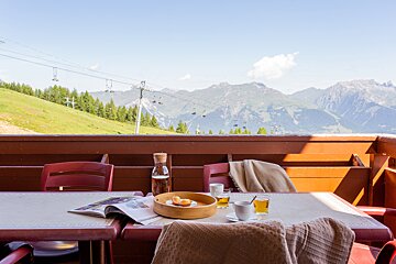 A table with a bowl of food and a magazine on it
