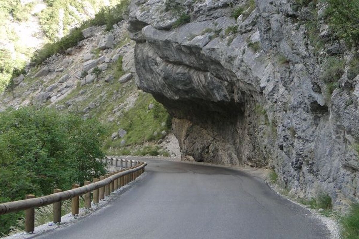 an overhanging rock on a road to the south of france
