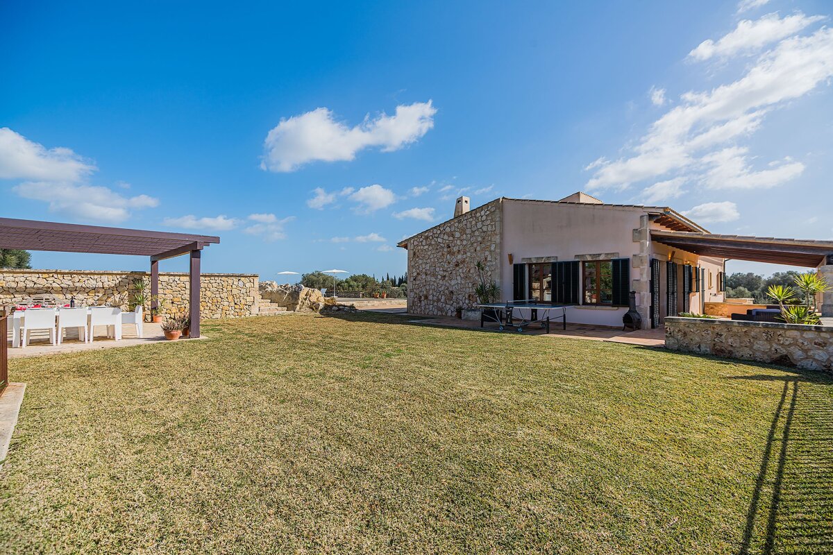 A house with a large lawn in front of it