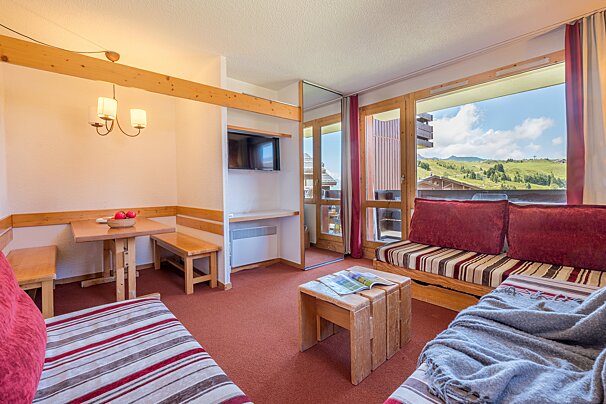 A living room with a couch a table and a television