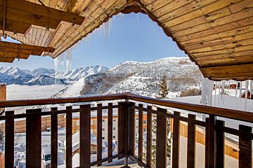 A balcony with a view of snow covered mountains