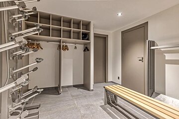 A locker room with a wooden bench and shelves