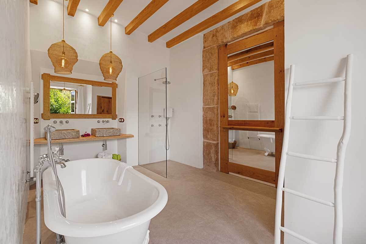 A bathroom with a bathtub and two sinks