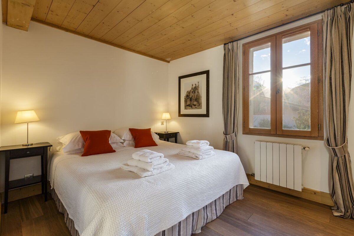 A bedroom with a large bed and a window