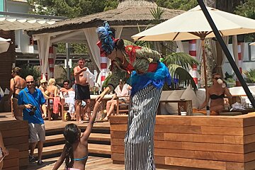 a circus clown & kid at nikki beach mallorca