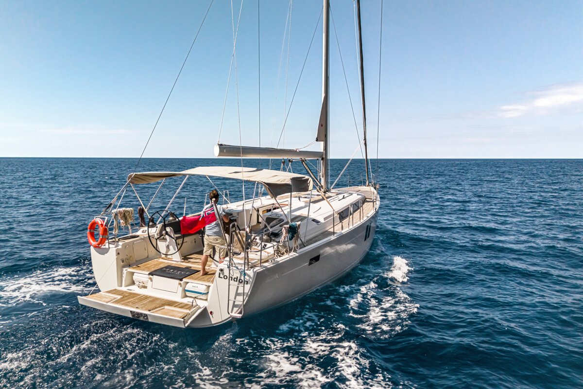 A sailboat is floating on top of a body of water