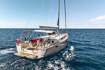 A sailboat is floating on top of a body of water