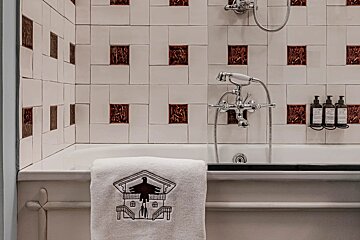 A bathtub with a towel that says ' aesop ' on it