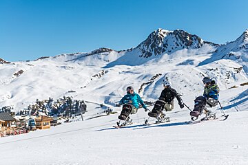 A group of people skiing down a snow covered slope