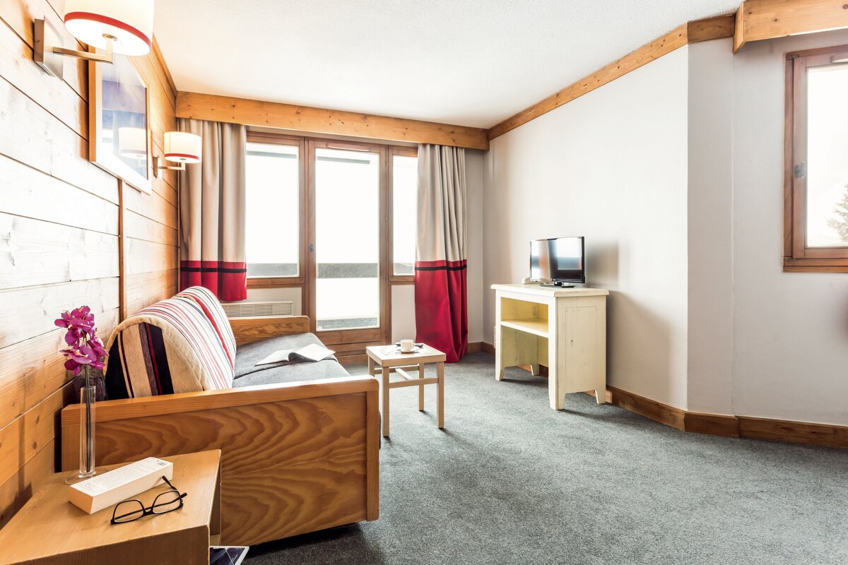 A living room with a couch and a television