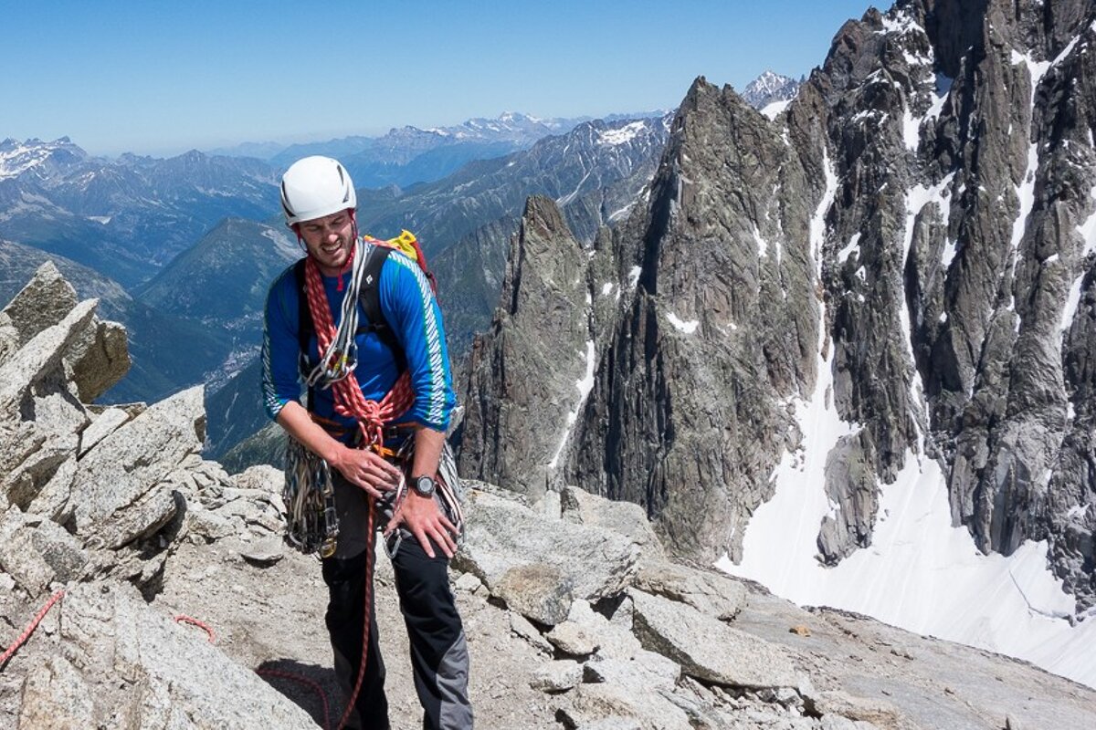 A man wearing a blue shirt that says ' altitude ' on it