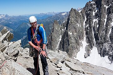 A man wearing a blue shirt that says ' altitude ' on it