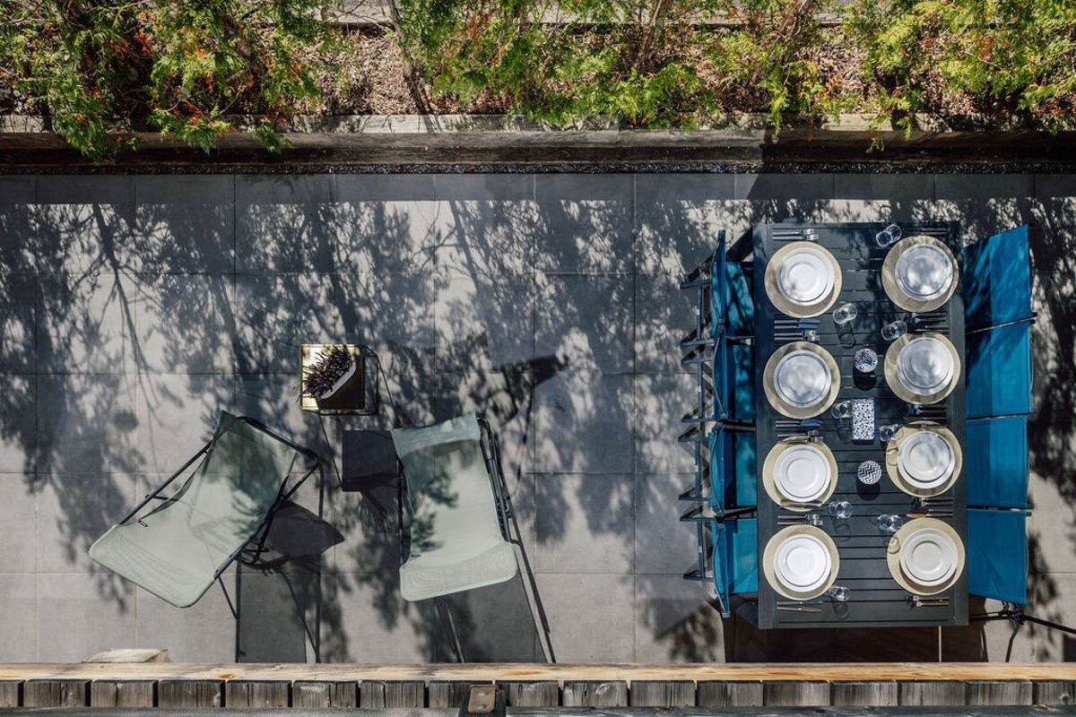 An aerial view of a patio with a table and chairs