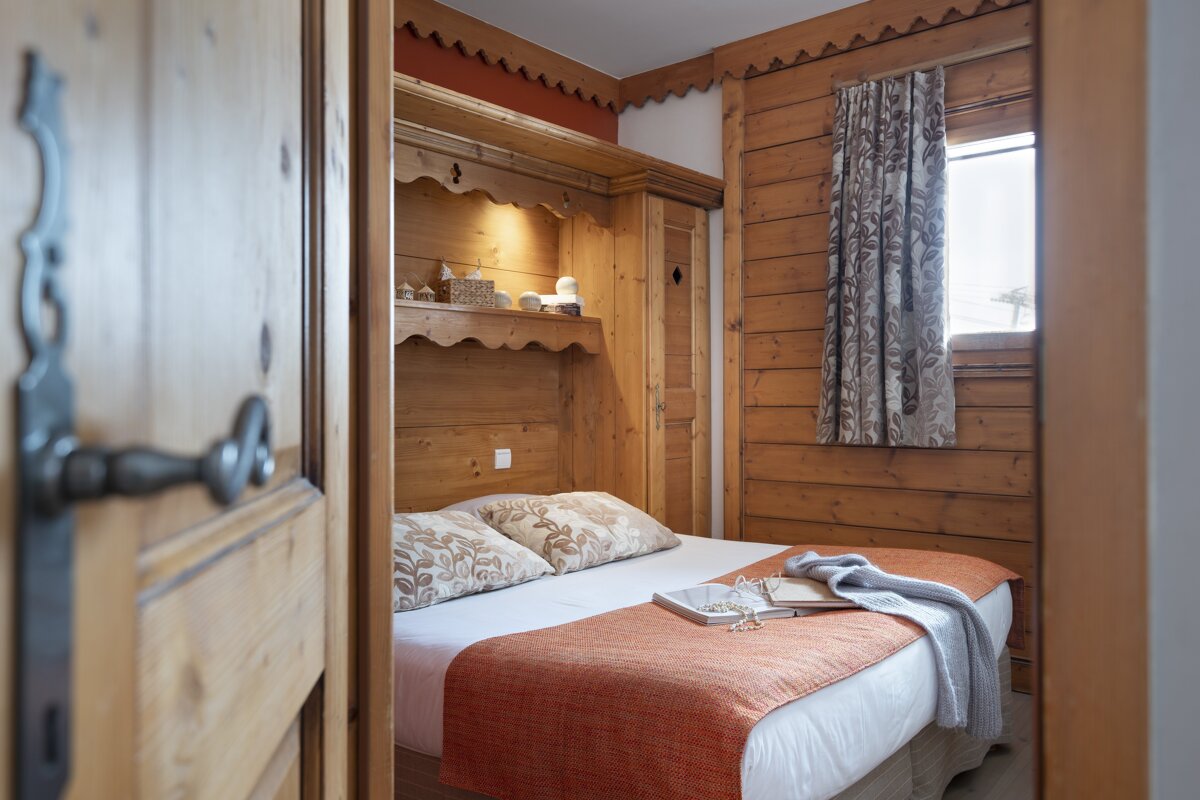 A bedroom with a bed and a book on it