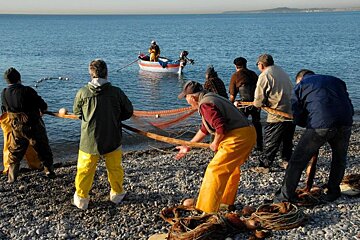 fishermen at the edge of the beach in Cagens sur Mer