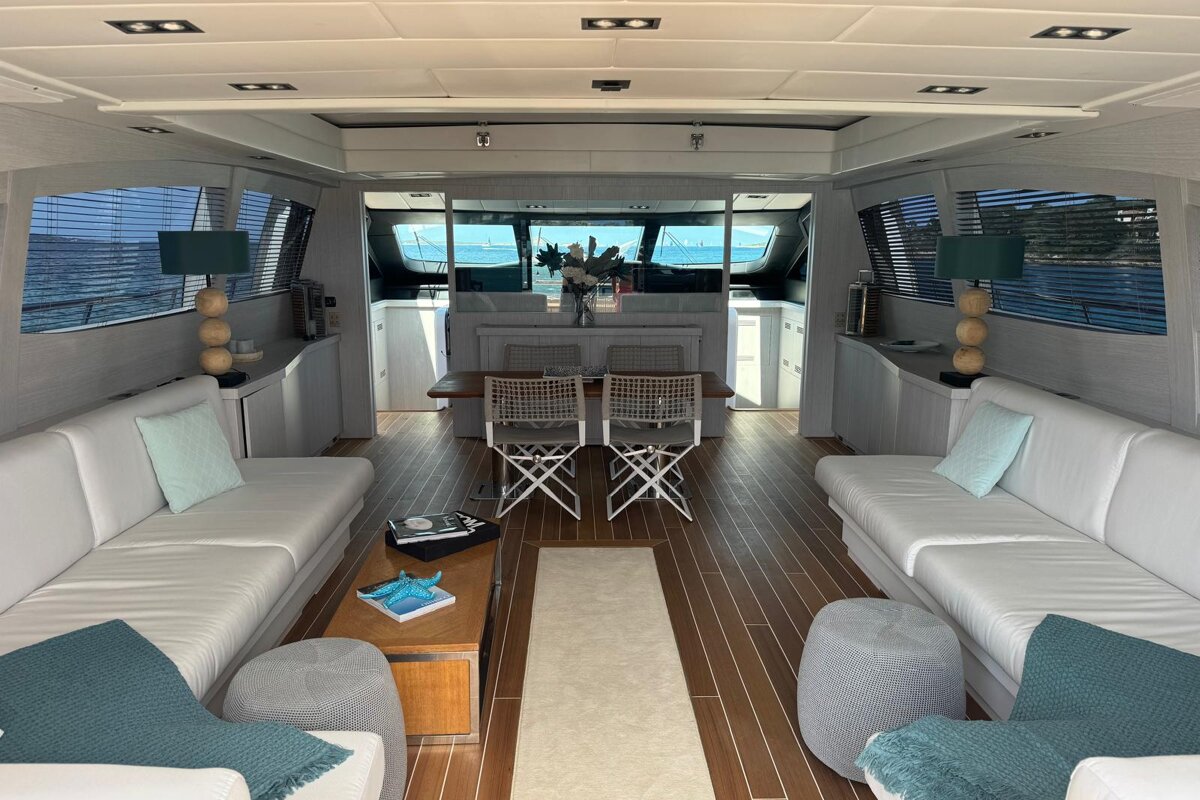 A living room on a boat with a table and chairs