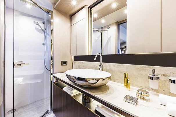 A bathroom with a sink a mirror and a shower