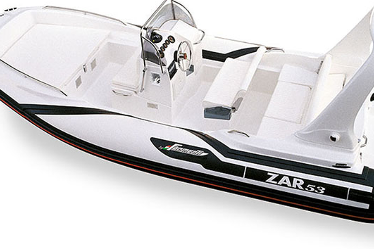 A white and black boat with zar53 written on the side