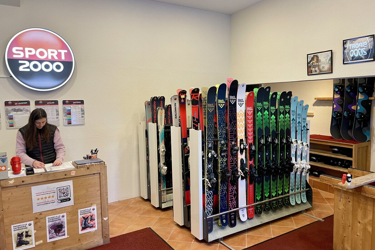 A woman behind a counter in a sport 2000 store