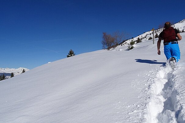 a man hiking through powder