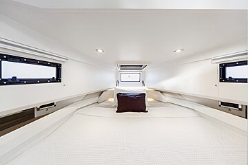The inside of a boat with a bed and a window