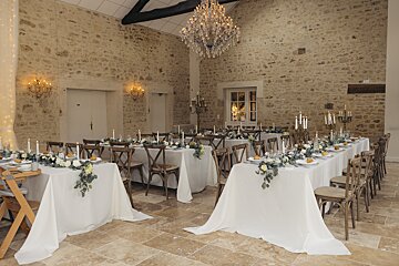 A large room with tables and chairs and a chandelier