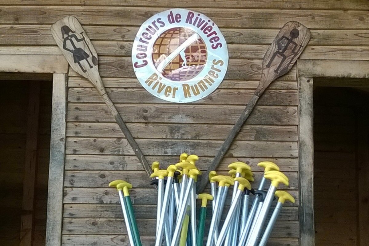 Paddle handles underneath the coureurs de rivières sign and two open doors