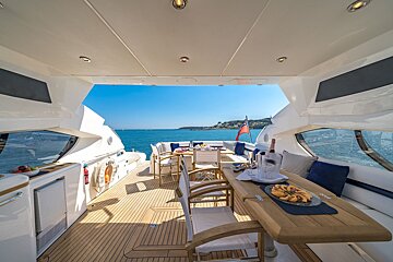 The inside of a boat with a table and chairs