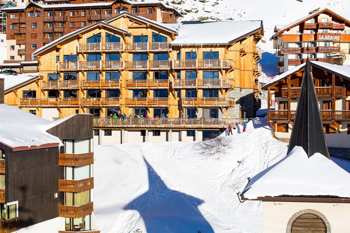 A snowy landscape with a building that says ' l' ermitage ' on it