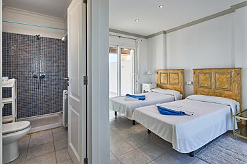 A bedroom with two twin beds and a toilet